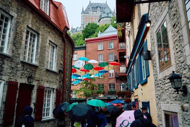Art stalls under an awning along Rue du Trésor in Old Québec